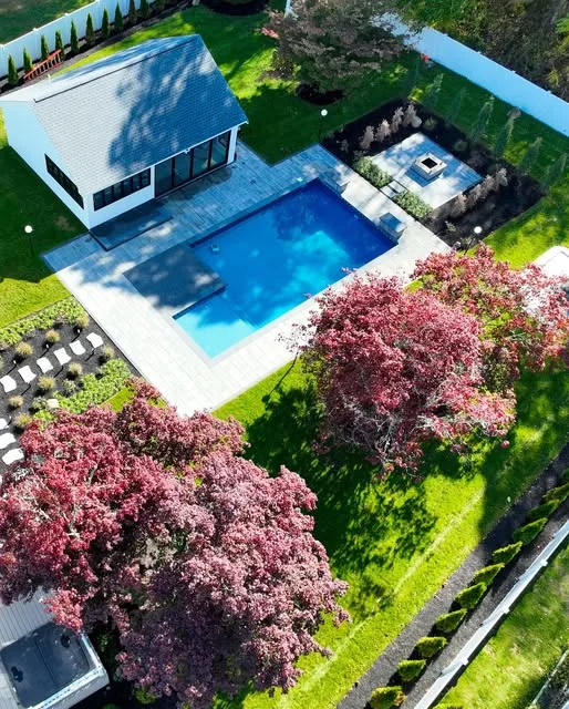 Aerial view of a finished pool, patio and garden