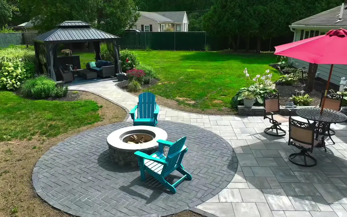 Stone patio and connecting paths around an outdoor seating area